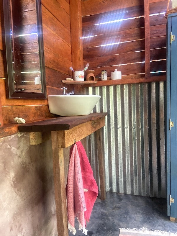 Rustic hardwood bathroom with a hand-built vanity and vessel sink
