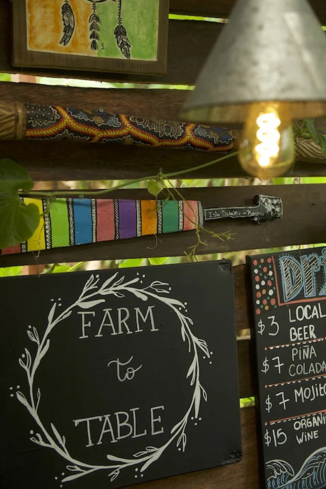 Hand-painted 'Farm to Table' and drinks-menu signs in the kitchen