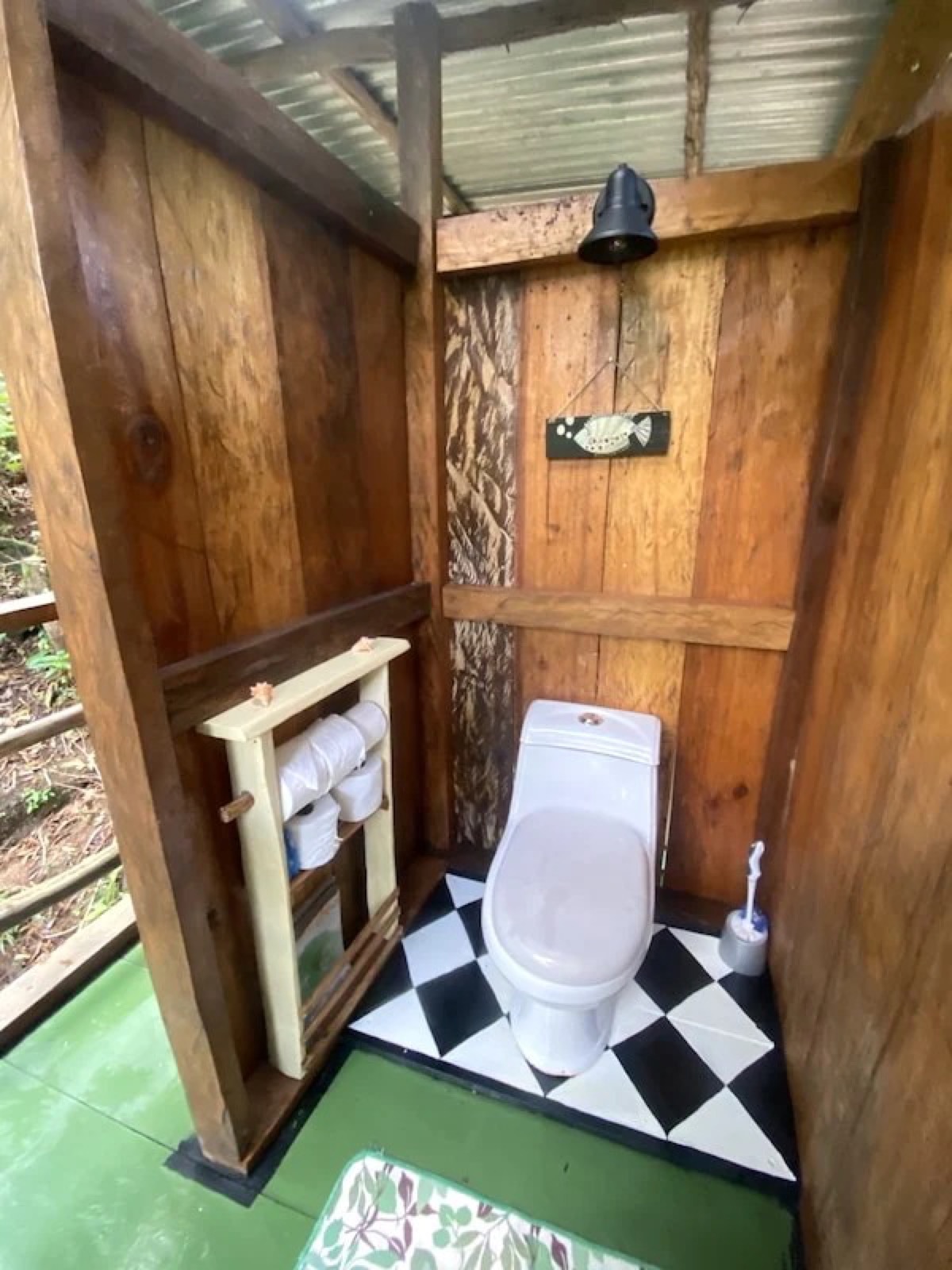 Hardwood toilet room with a black-and-white checkerboard tile floor