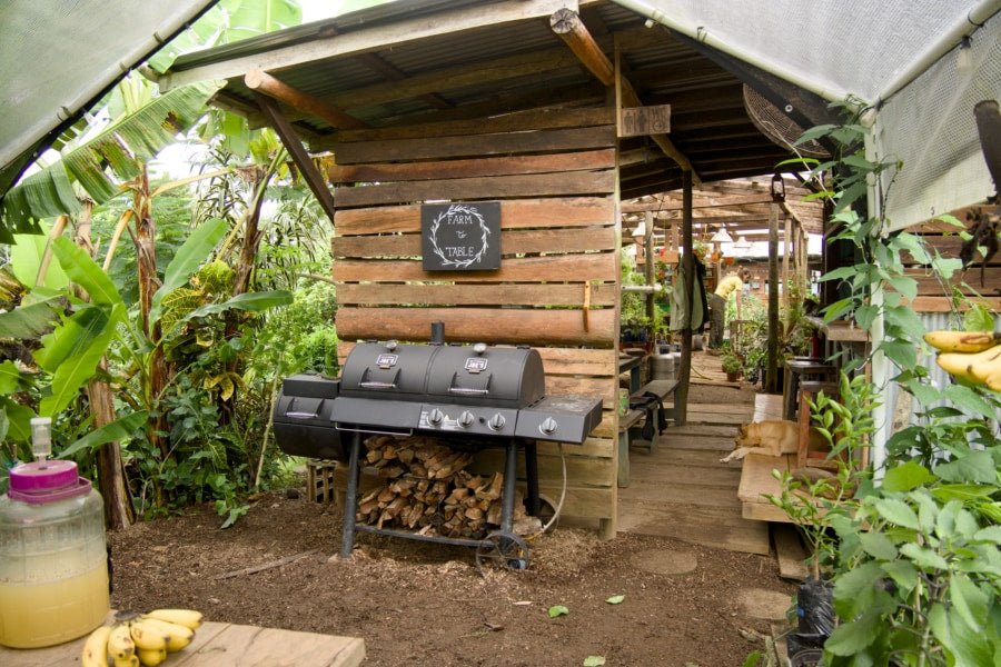 Open-air farm-to-table kitchen built from hardwood, with a grill